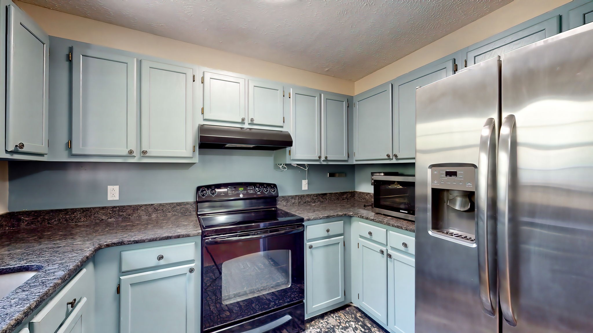 137 Gaskins Road Dickson, TN 37055 - Photo 26 of 58 a kitchen with stainless steel appliances granite countertop a refrigerator a stove and a sink with cabinets