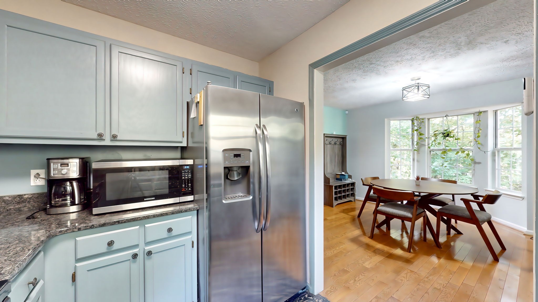 137 Gaskins Road Dickson, TN 37055 - Photo 27 of 58 a kitchen with stainless steel appliances granite countertop a refrigerator a stove a dining table and chairs with wooden floor