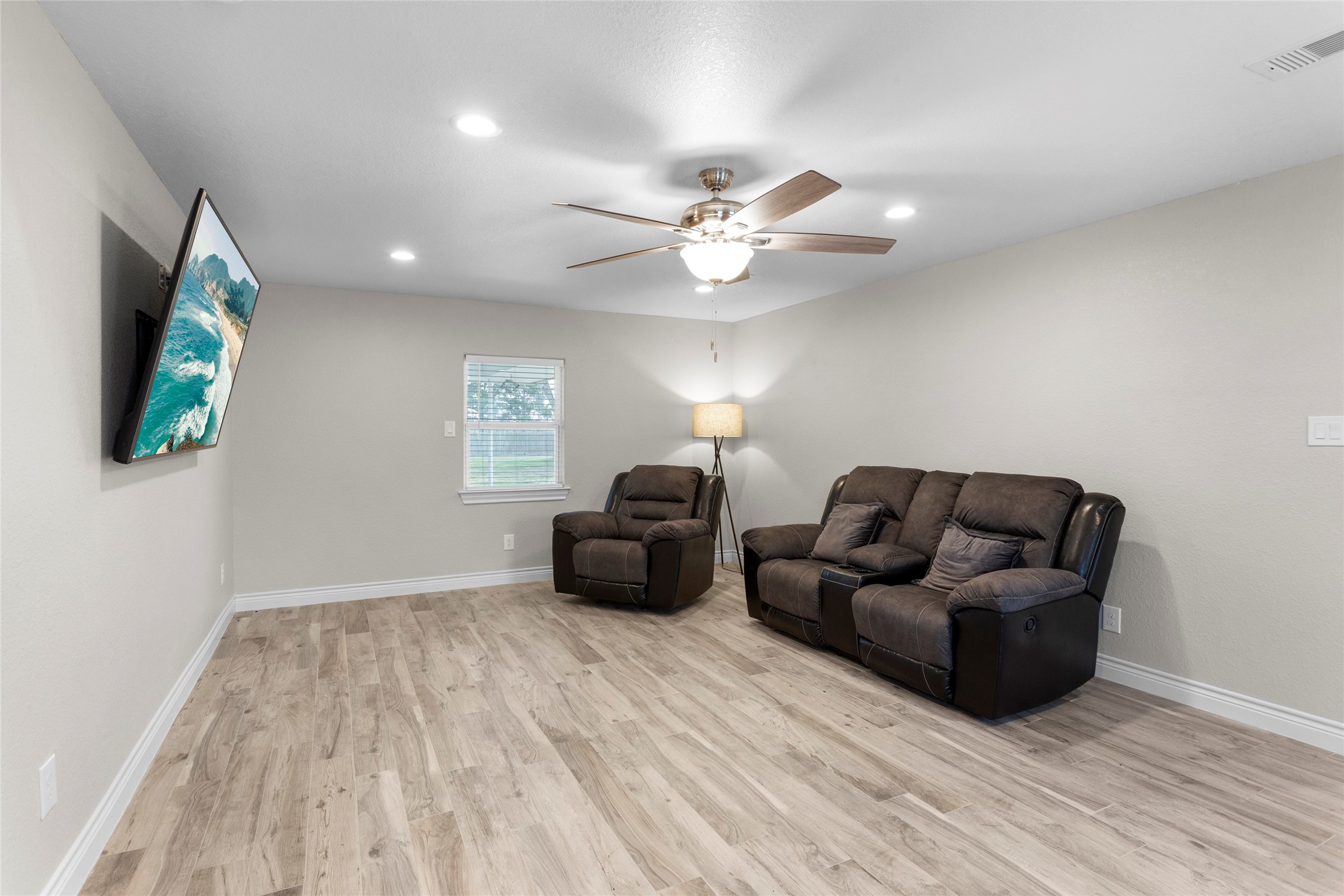 13800 West 6th Street Santa Fe, TX 77517 - Photo 14 of 35 a living room with furniture and a wooden floor