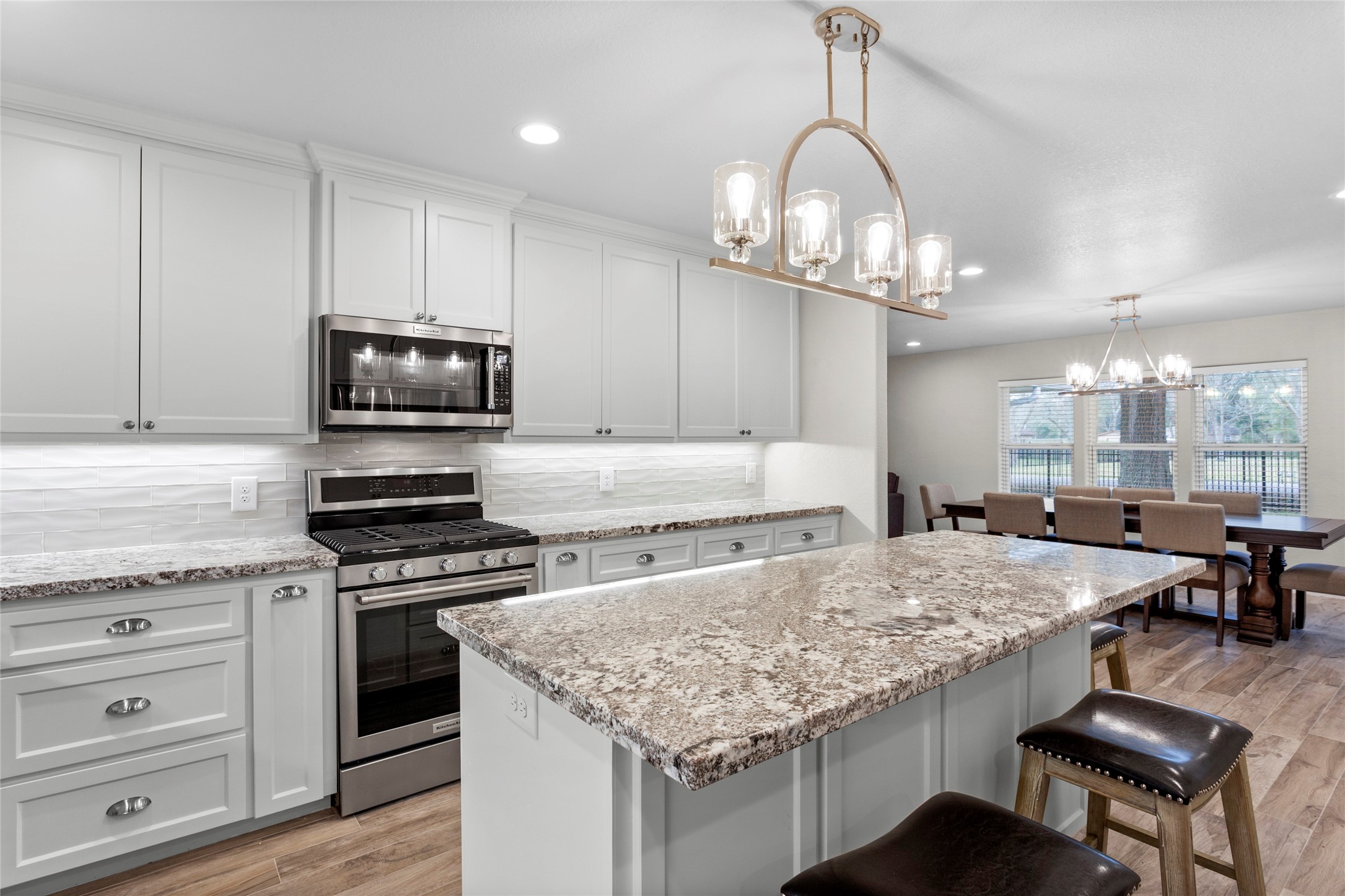 13800 West 6th Street Santa Fe, TX 77517 - Photo 15 of 35 a kitchen with kitchen island granite countertop a sink cabinets and stainless steel appliances