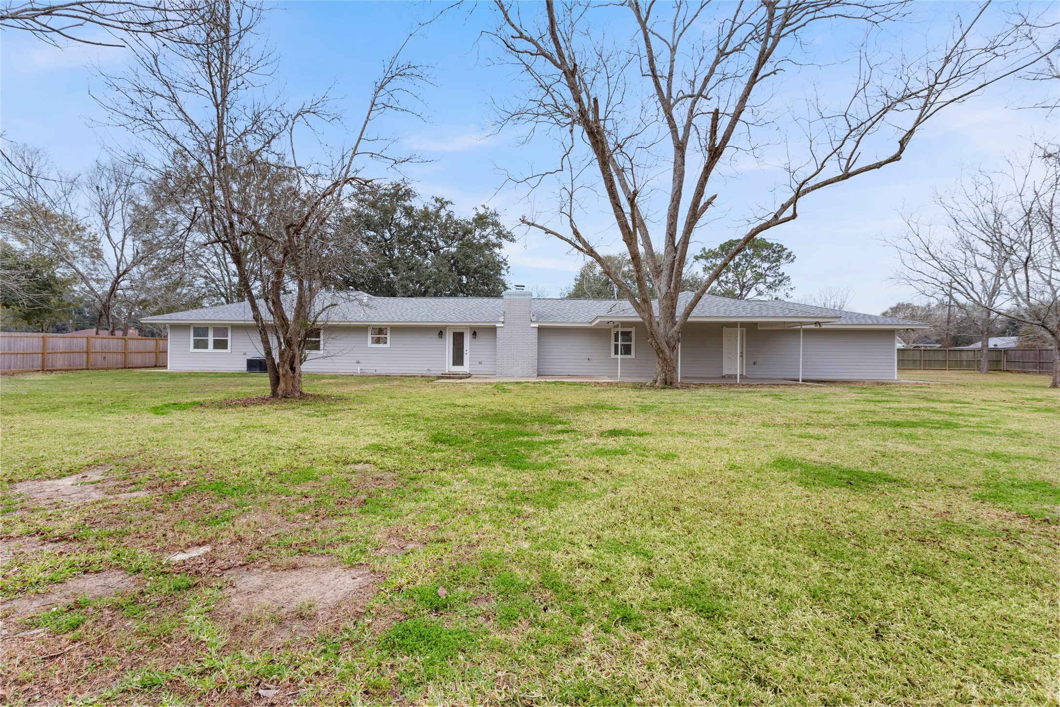 13800 West 6th Street Santa Fe, TX 77517 - Photo 30 of 35 a front view of house with yard and trees