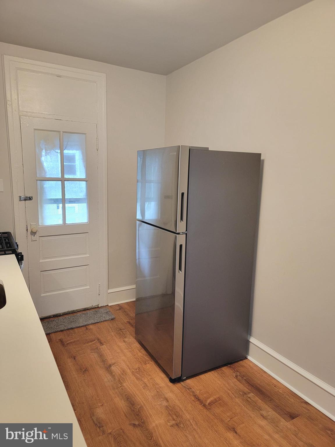 56 East Spring Avenue, Unit 2 Ardmore, PA 19003 - Photo 3 of 12 a view of empty room with wooden floor and window