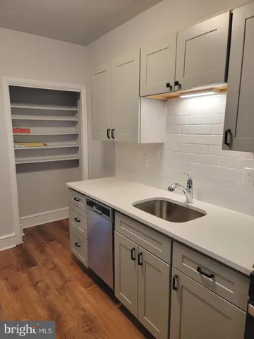 a kitchen with a sink and cabinets