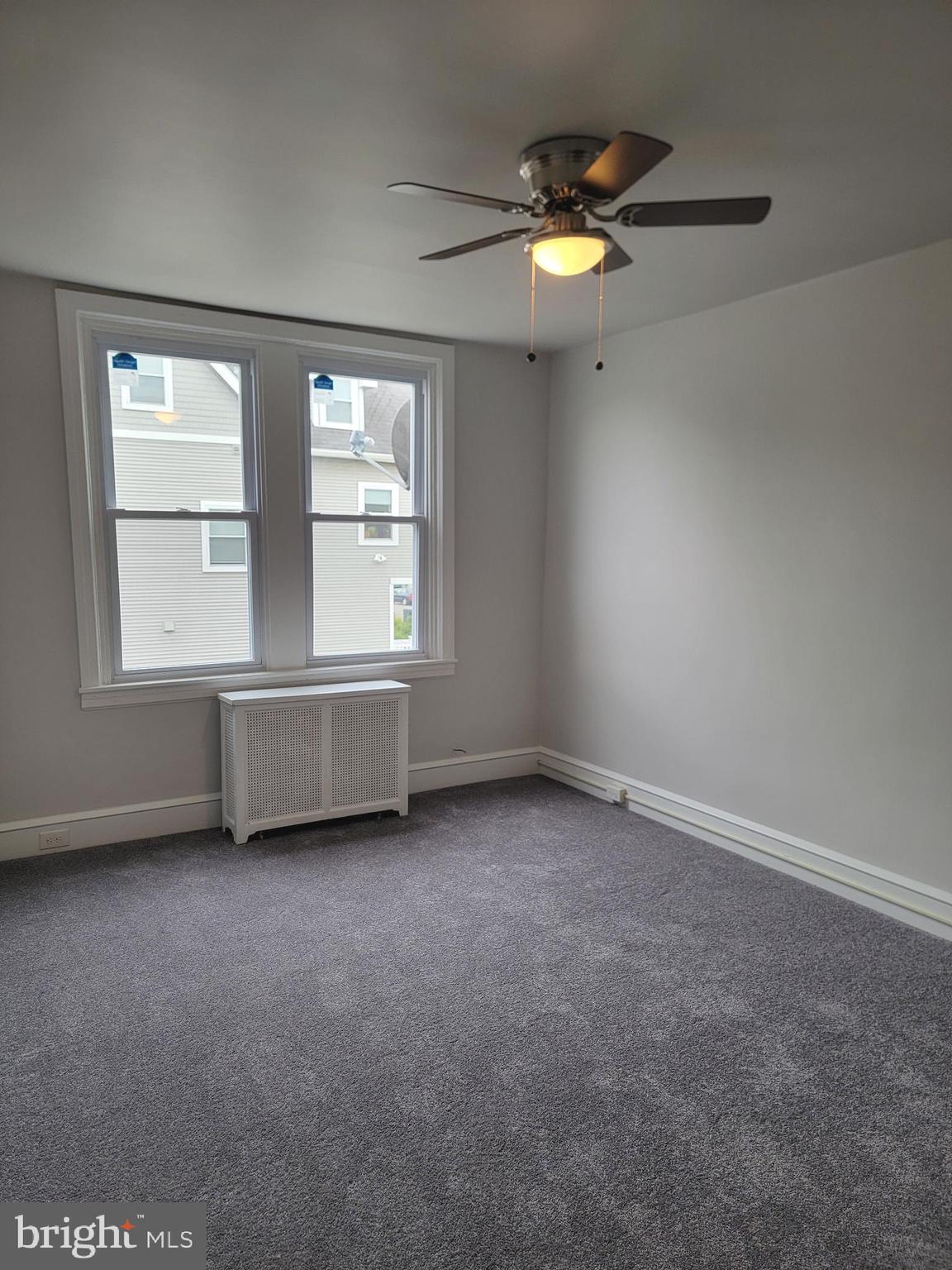 56 East Spring Avenue, Unit 2 Ardmore, PA 19003 - Photo 6 of 12 an empty room with windows and fan
