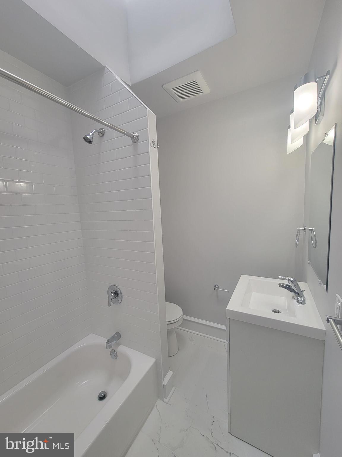 56 East Spring Avenue, Unit 2 Ardmore, PA 19003 - Photo 8 of 12 a bathroom with a sink a toilet and shower