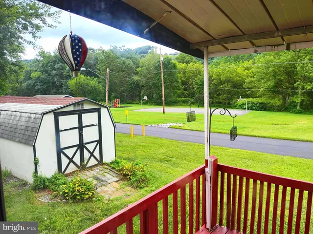 a view of a wooden deck with a yard