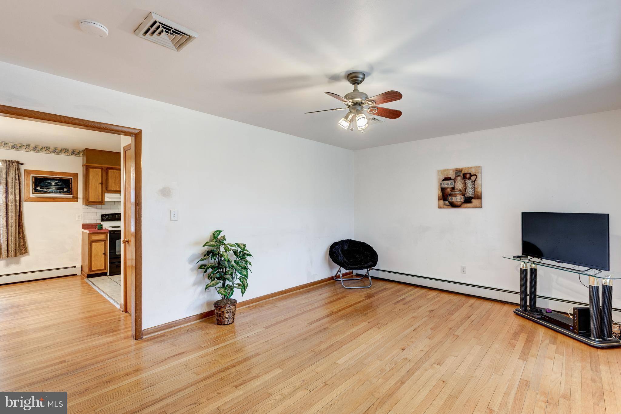 529 Key Heights Road Union Bridge, MD 21791 - Photo 8 of 45 a view of a livingroom with a hardwood floor and a ceiling fan