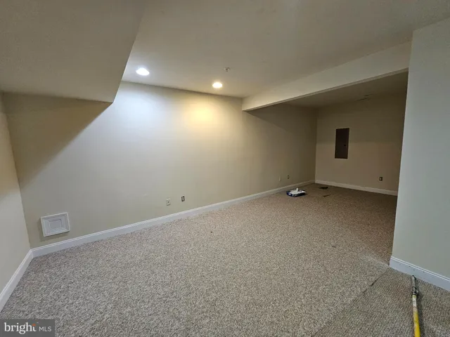 a bathroom with a granite countertop bathtub shower sink vanity and toilet