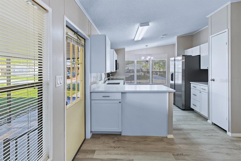 2828 Southwest Toronado Trail Stuart, FL 34997 - Photo 11 of 46 a kitchen with a refrigerator and a sink