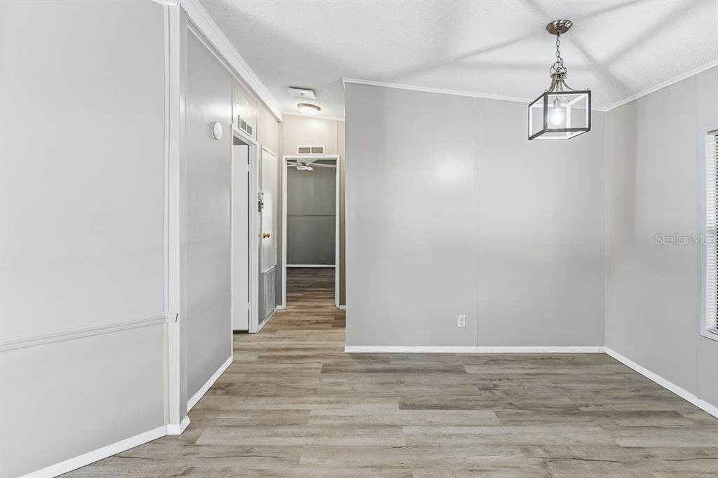 2828 Southwest Toronado Trail Stuart, FL 34997 - Photo 15 of 46 a view of a hallway with wooden floor