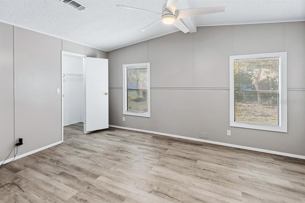 2828 Southwest Toronado Trail Stuart, FL 34997 - Photo 16 of 46 wooden floor in an empty room with a window