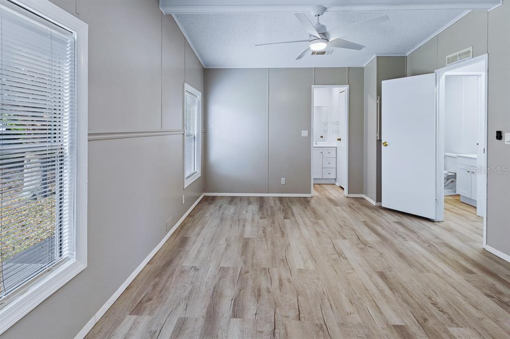2828 Southwest Toronado Trail Stuart, FL 34997 - Photo 18 of 46 wooden floor in an empty room with a window