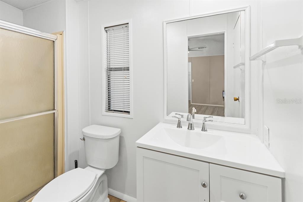 2828 Southwest Toronado Trail Stuart, FL 34997 - Photo 19 of 46 a bathroom with a sink a toilet and shower