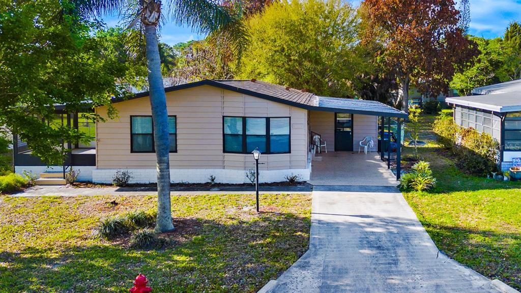 2828 Southwest Toronado Trail Stuart, FL 34997 - Photo 2 of 46 a house view with swimming pool and garden space
