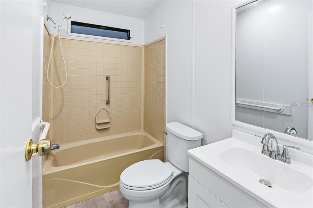 2828 Southwest Toronado Trail Stuart, FL 34997 - Photo 23 of 46 a bathroom with a sink toilet and shower