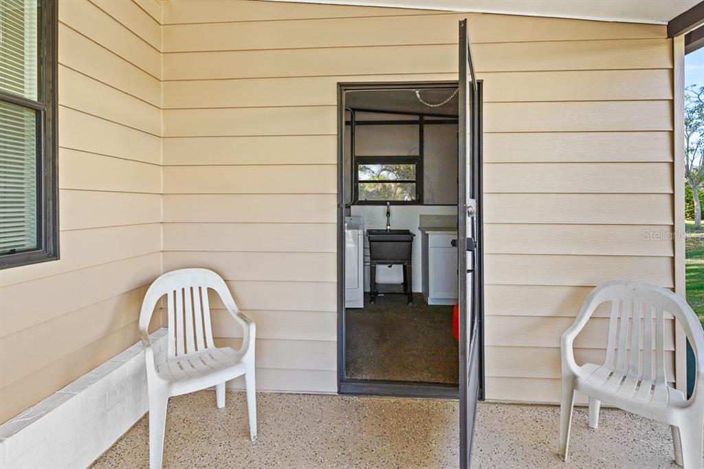 2828 Southwest Toronado Trail Stuart, FL 34997 - Photo 25 of 46 a front view of a house with a balcony