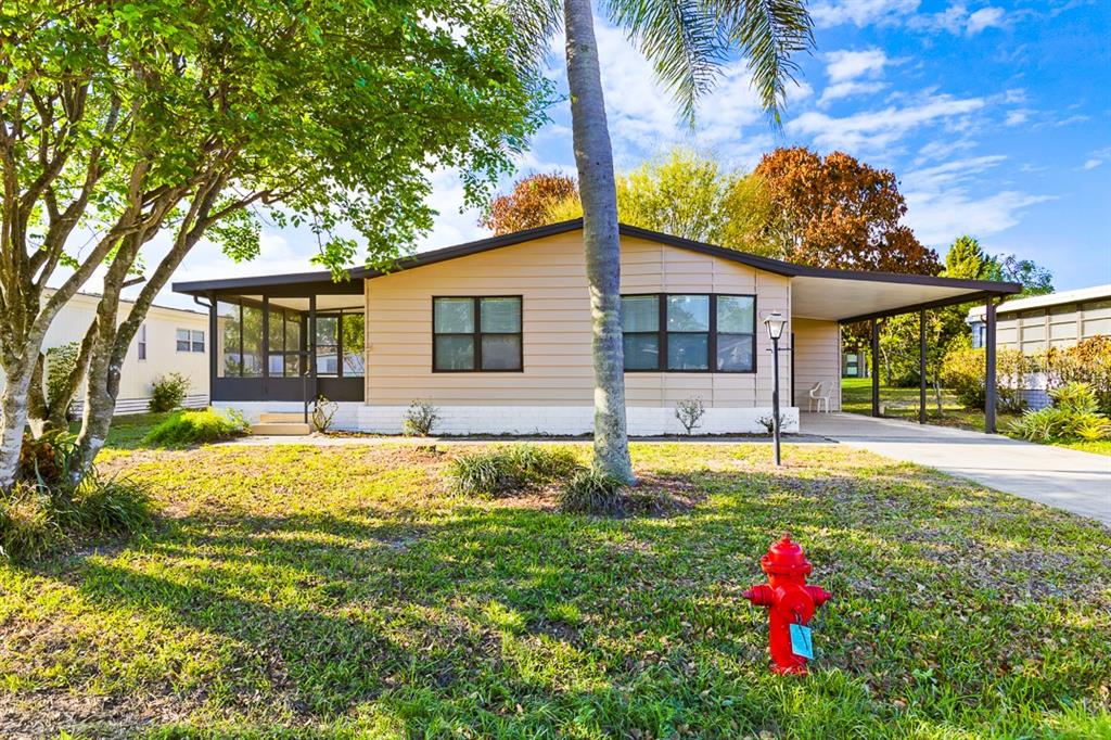 2828 Southwest Toronado Trail Stuart, FL 34997 - Photo 29 of 46 a front view of a house with a yard
