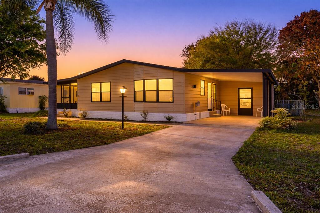 2828 Southwest Toronado Trail Stuart, FL 34997 - Photo 30 of 46 a front view of a house with a yard and garage