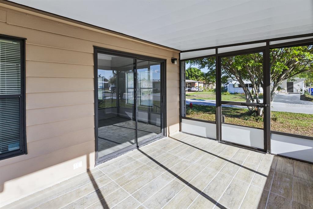 2828 Southwest Toronado Trail Stuart, FL 34997 - Photo 3 of 46 a view of empty room with wooden floor and floor to ceiling window