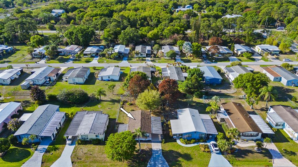 2828 Southwest Toronado Trail Stuart, FL 34997 - Photo 32 of 46 an aerial view of residential houses and car parked