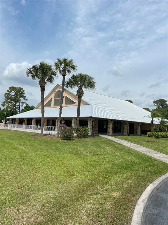 2828 Southwest Toronado Trail Stuart, FL 34997 - Photo 41 of 46 a front view of a house with a garden