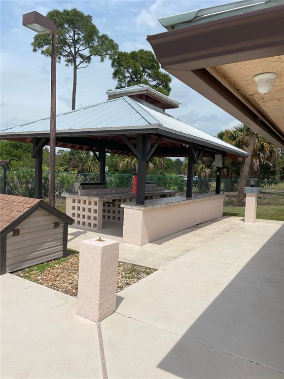 2828 Southwest Toronado Trail Stuart, FL 34997 - Photo 42 of 46 a view of a swimming pool with a patio