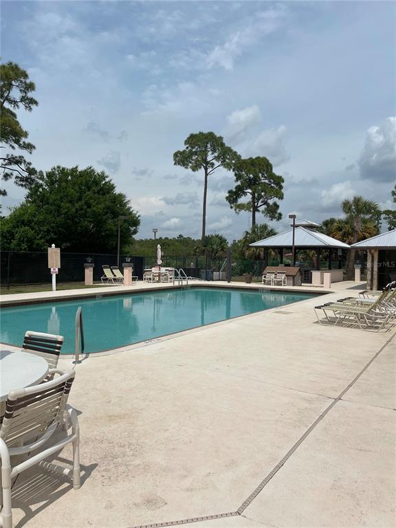 2828 Southwest Toronado Trail Stuart, FL 34997 - Photo 43 of 46 a view of a lake with a house in the background
