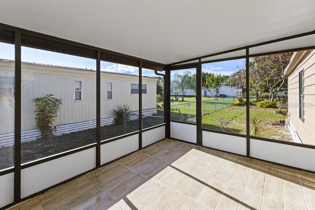 2828 Southwest Toronado Trail Stuart, FL 34997 - Photo 5 of 46 a view of a glass door with a glass door