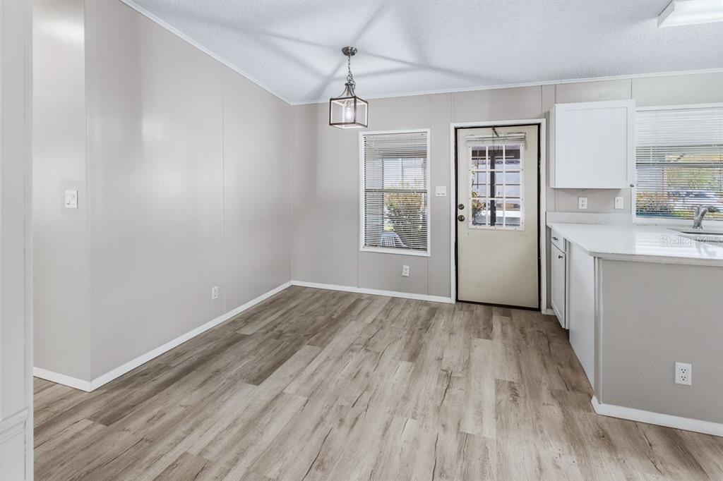 2828 Southwest Toronado Trail Stuart, FL 34997 - Photo 8 of 46 wooden floor in an empty room with a window