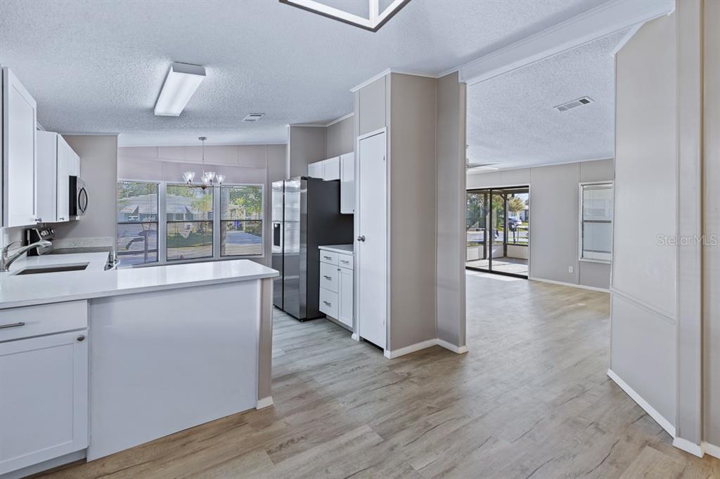 2828 Southwest Toronado Trail Stuart, FL 34997 - Photo 10 of 46 a kitchen with stainless steel appliances a refrigerator sink and cabinets