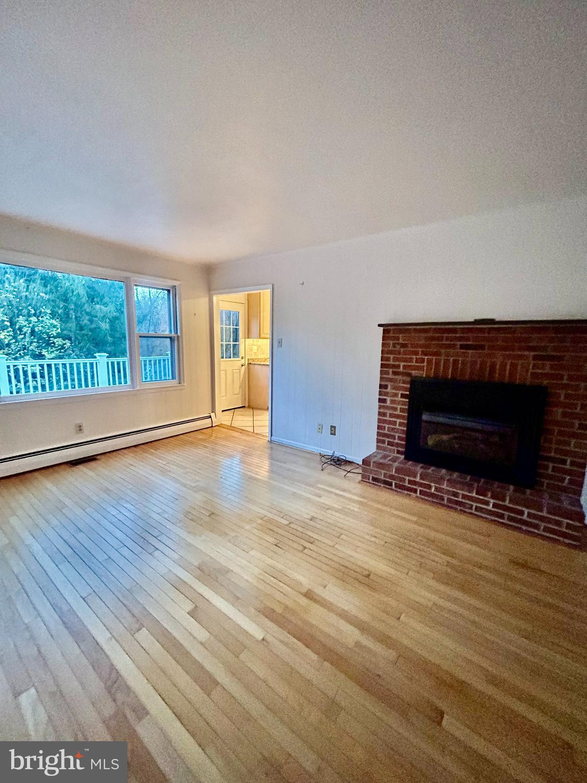 1007 Jones Road Conshohocken, PA 19428 - Photo 13 of 26 a view of empty room with wooden floor and fireplace