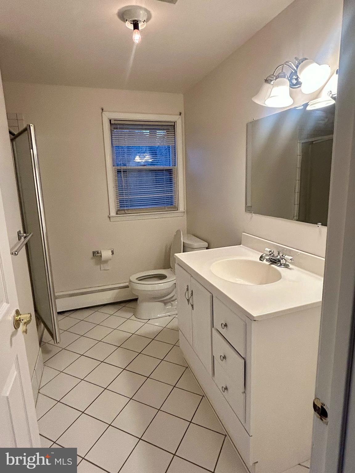 1007 Jones Road Conshohocken, PA 19428 - Photo 17 of 26 a bathroom with a double vanity sink mirror and toilet