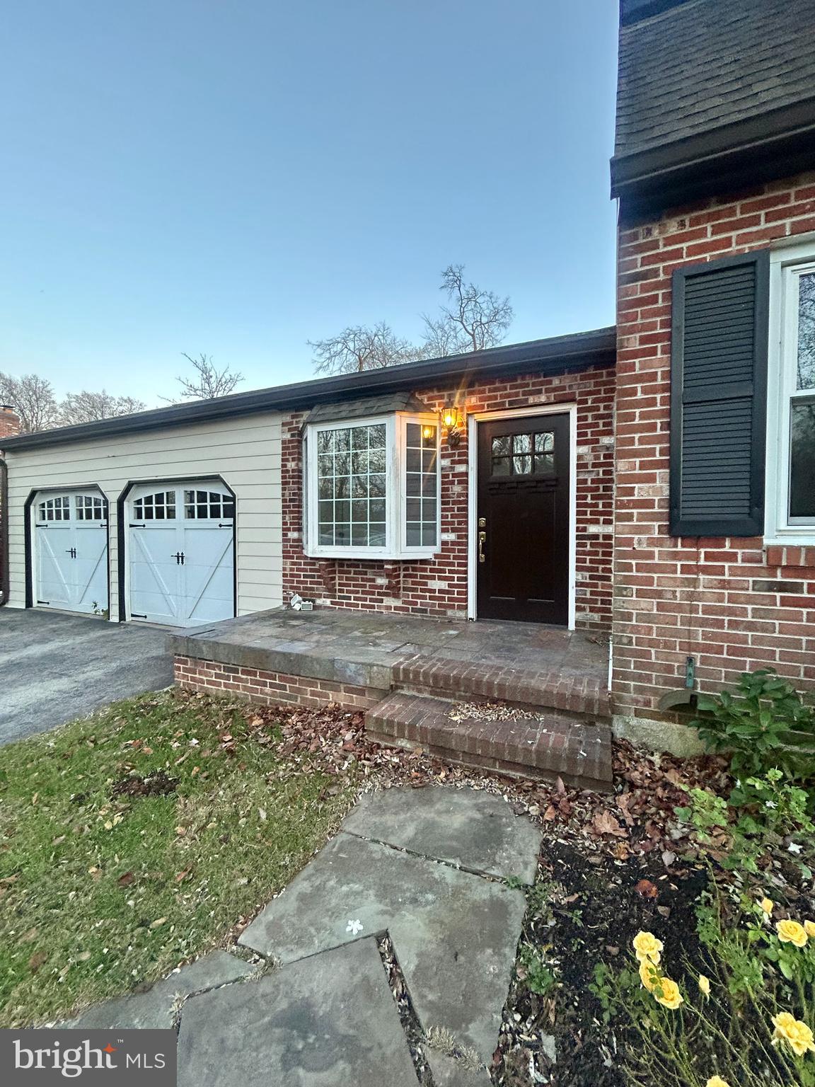 1007 Jones Road Conshohocken, PA 19428 - Photo 24 of 26 a front view of a house with a yard and garage