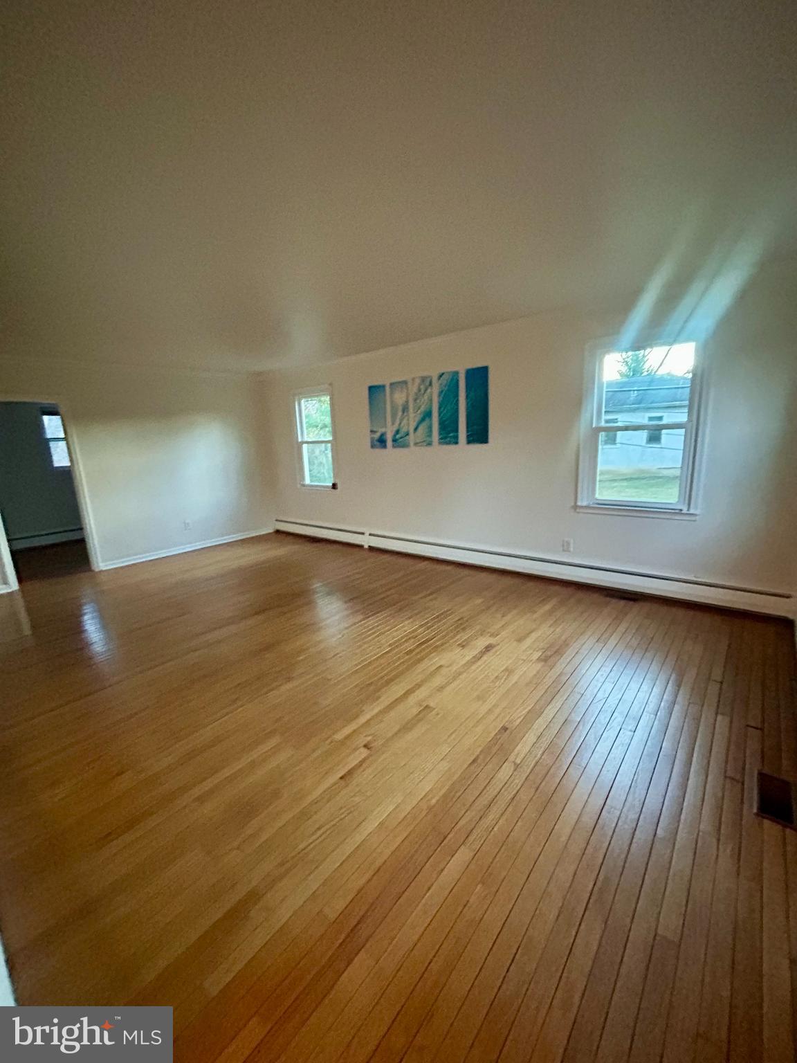 1007 Jones Road Conshohocken, PA 19428 - Photo 4 of 26 a view of empty room with wooden floor and fan