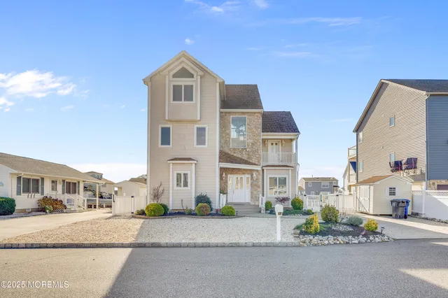 an aerial view of residential houses with outdoor space and seating area