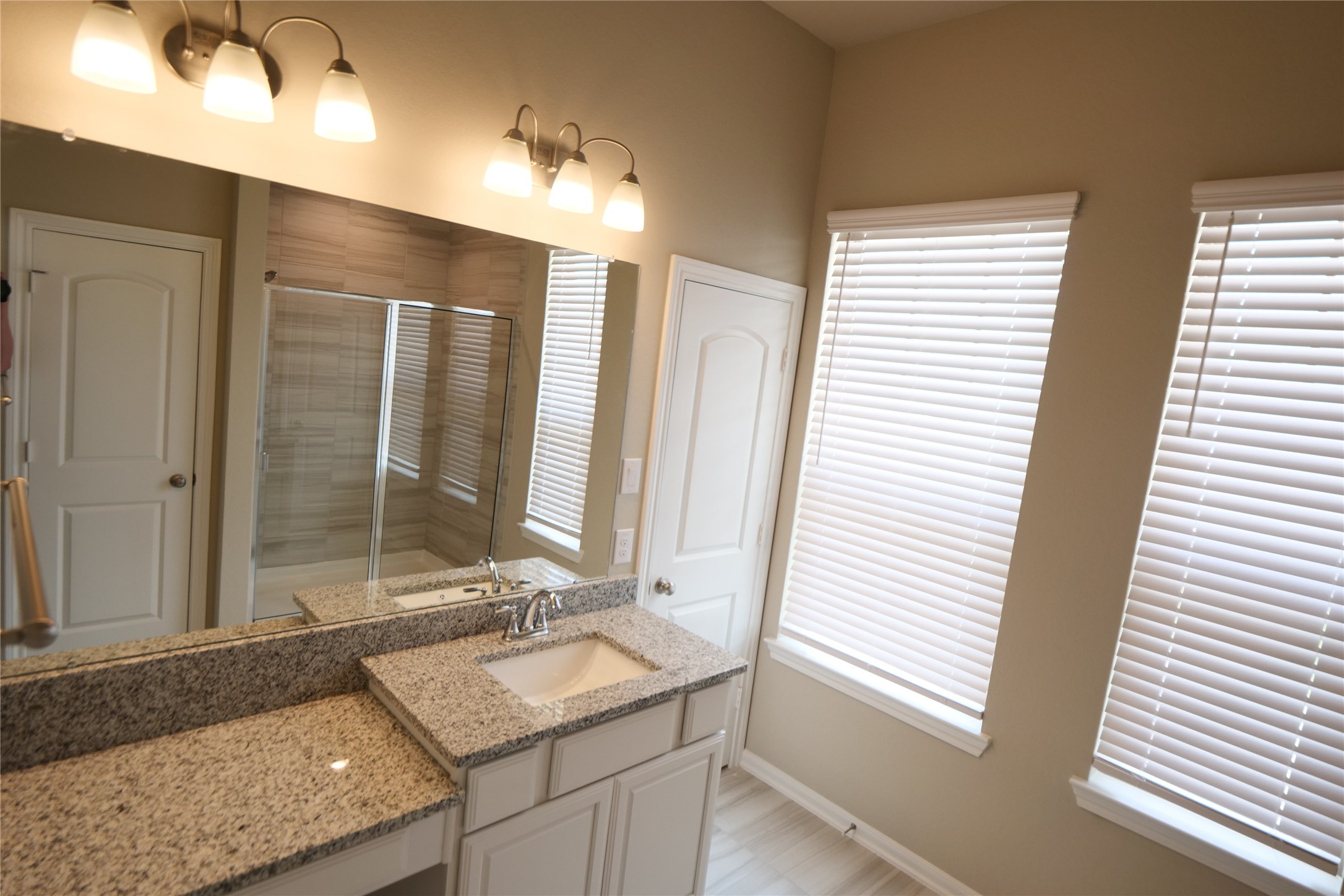 5110 Prairie Terrace Fulshear, TX 77441 - Photo 19 of 31 a bathroom with a granite countertop sink and a mirror