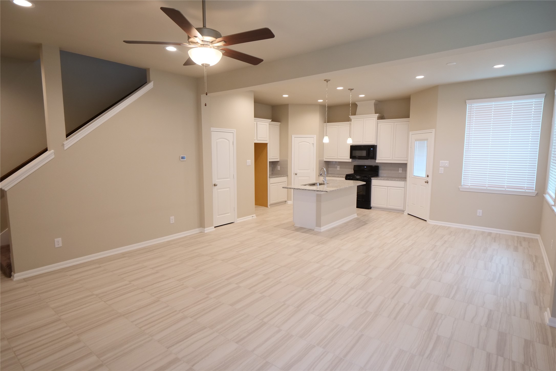5110 Prairie Terrace Fulshear, TX 77441 - Photo 3 of 31 a view of kitchen with refrigerator stove and wooden floor
