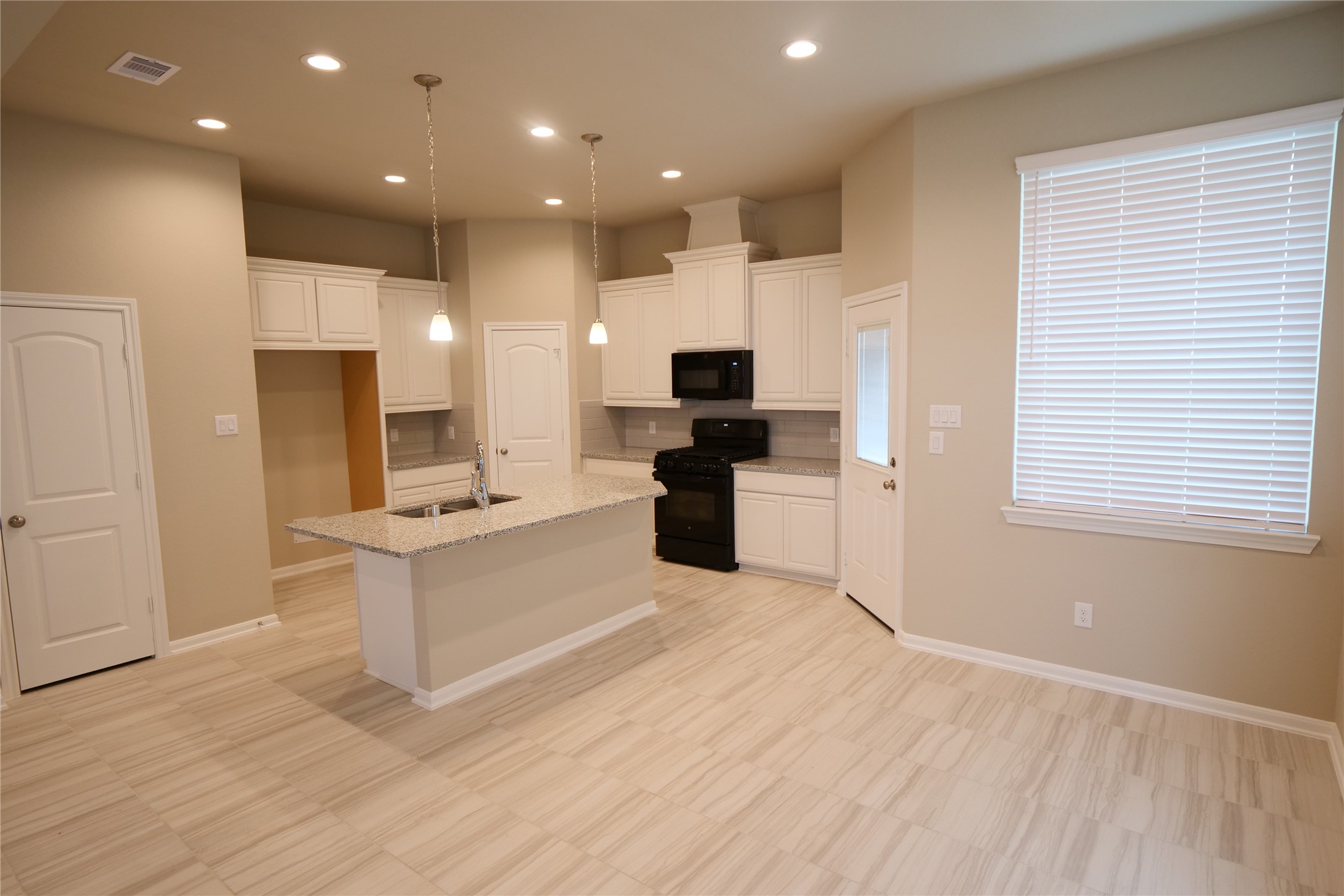5110 Prairie Terrace Fulshear, TX 77441 - Photo 7 of 31 a large kitchen with a center island wooden floor and stainless steel appliances