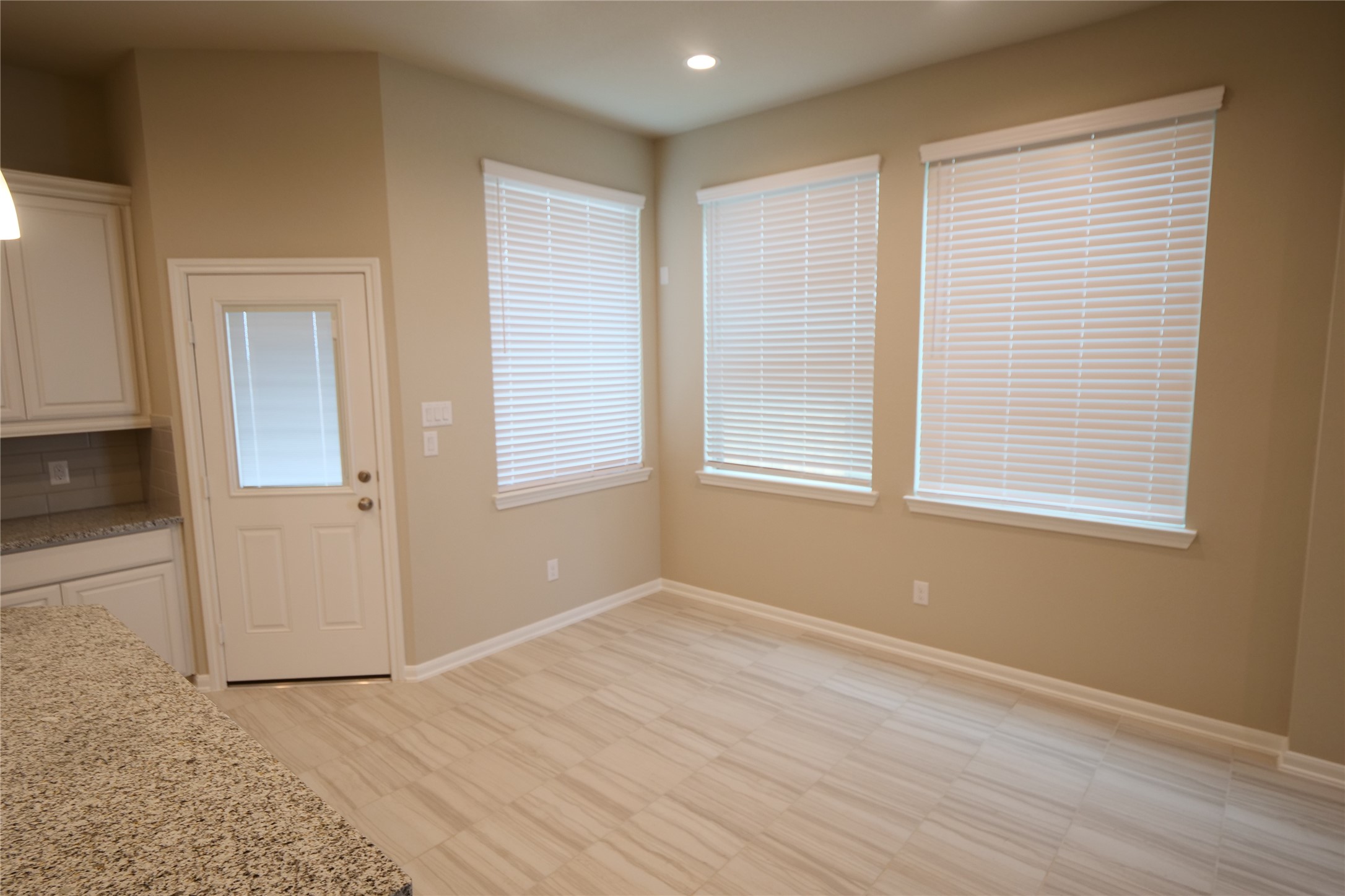 5110 Prairie Terrace Fulshear, TX 77441 - Photo 10 of 31 an empty room with wooden floor and windows