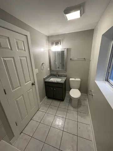 a bathroom with a sink a toilet and a mirror