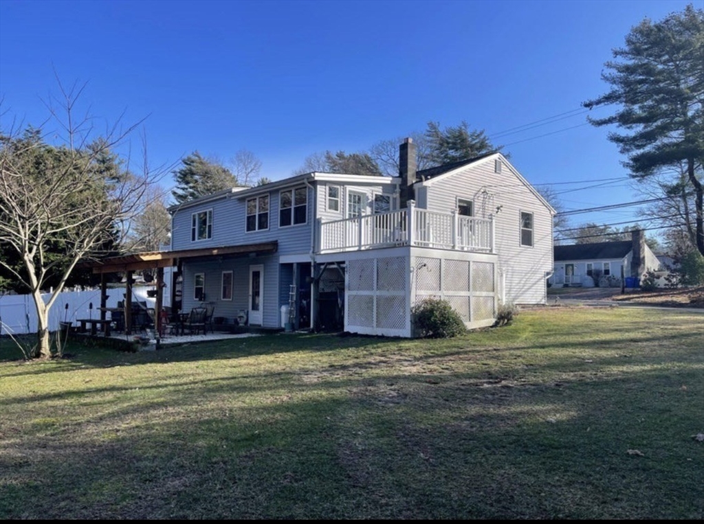 8 Scraggy Neck Rd Extension Bourne, MA 02534 - Photo 3 of 17 a view of a big house with a big yard and large trees