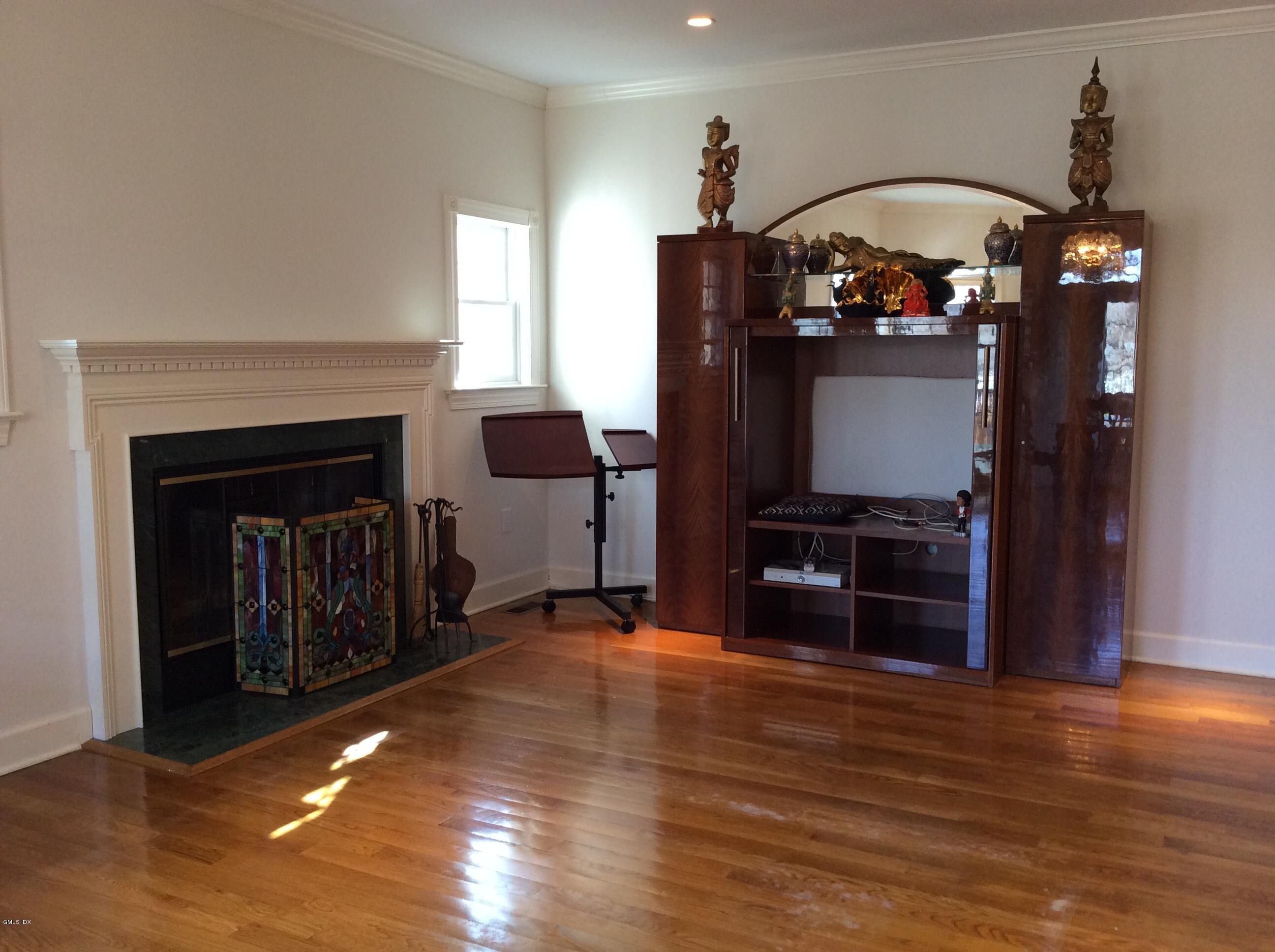 3 Stanwich Road Greenwich, CT 06830 - Photo 15 of 17 a living room with furniture a flat screen tv and a fireplace