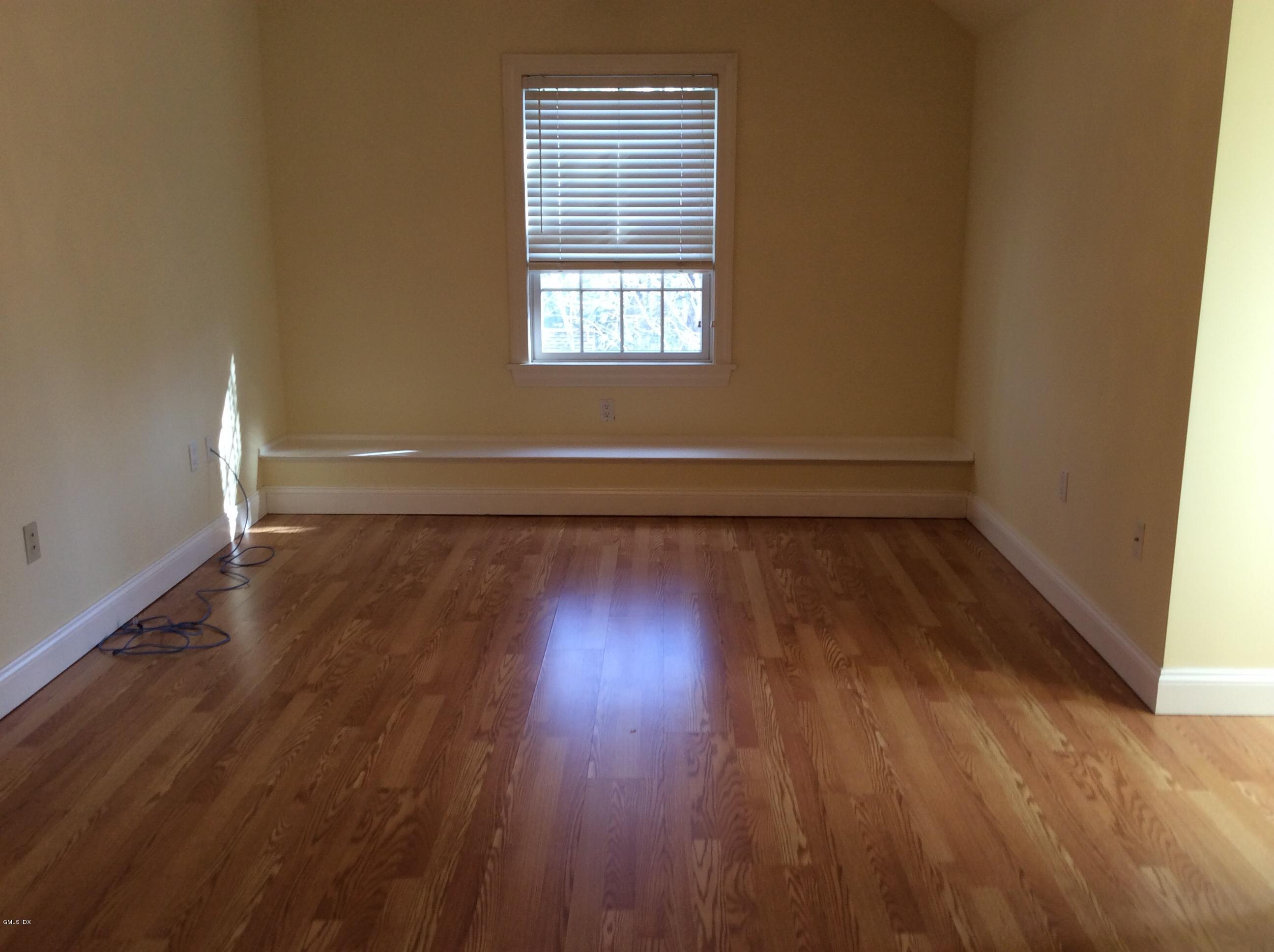 3 Stanwich Road Greenwich, CT 06830 - Photo 16 of 17 an empty room with wooden floor and windows