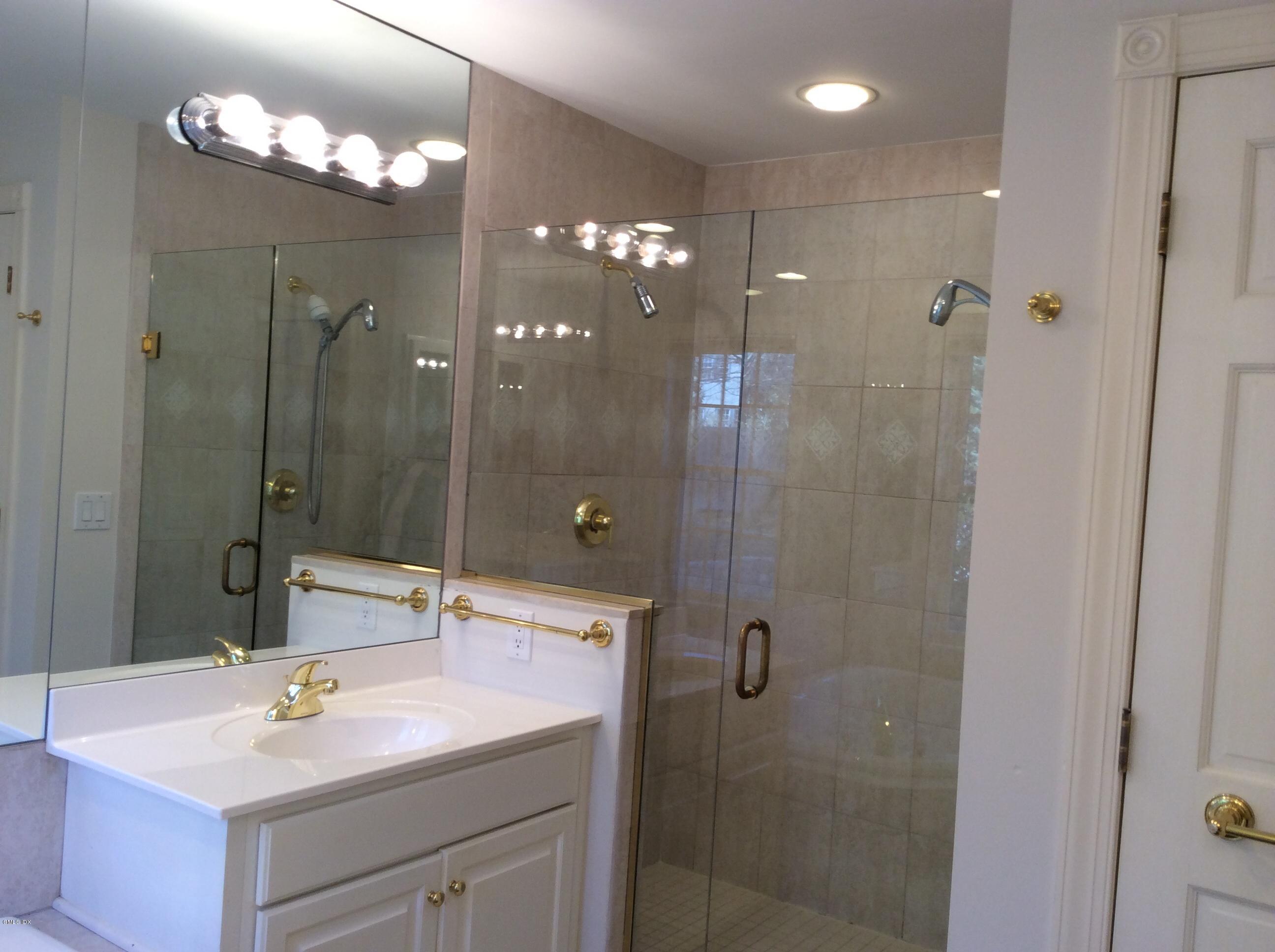 3 Stanwich Road Greenwich, CT 06830 - Photo 6 of 17 a bathroom with a sink shower and a mirror