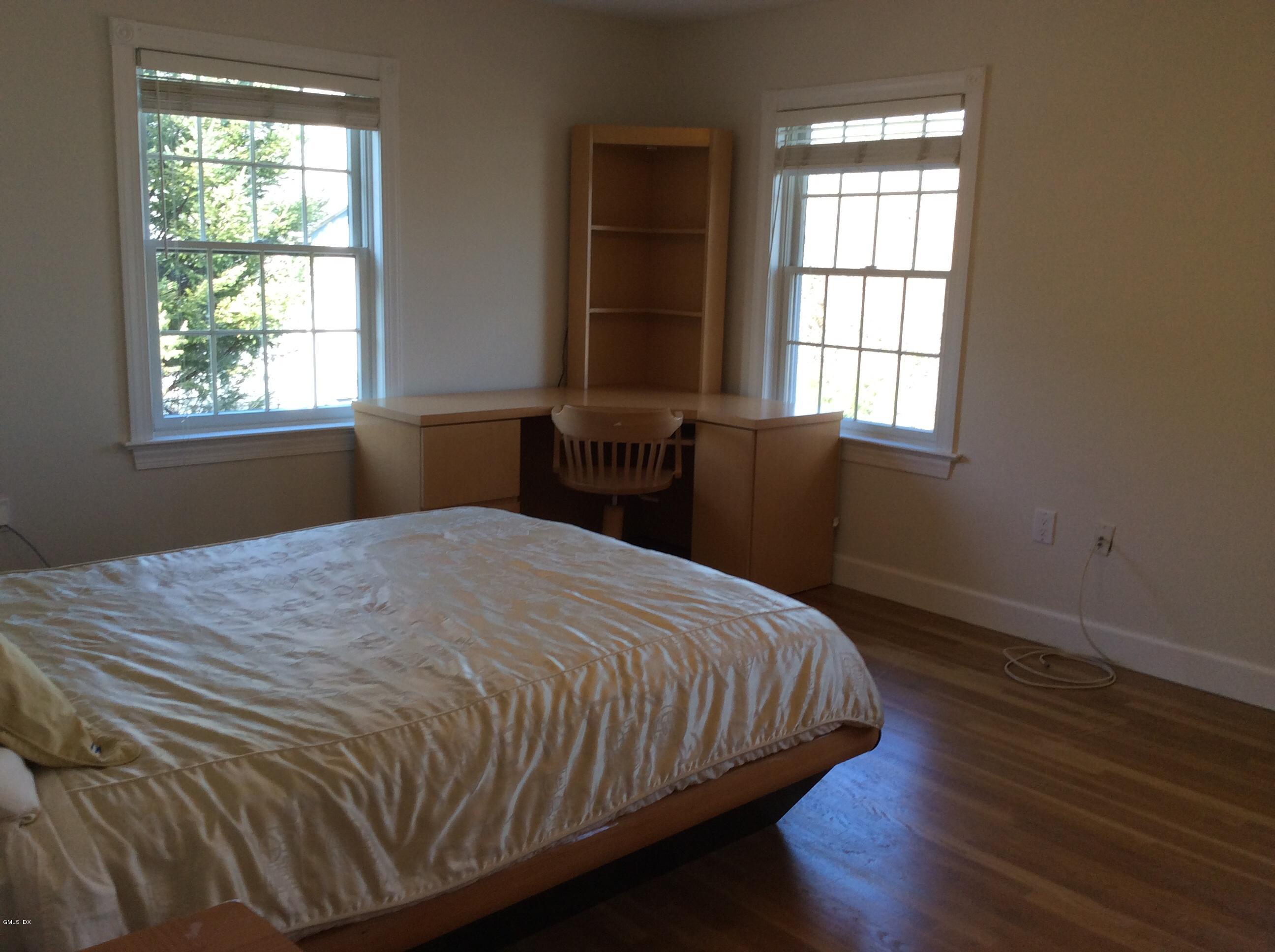 3 Stanwich Road Greenwich, CT 06830 - Photo 7 of 17 a bedroom with a bed and wooden floor
