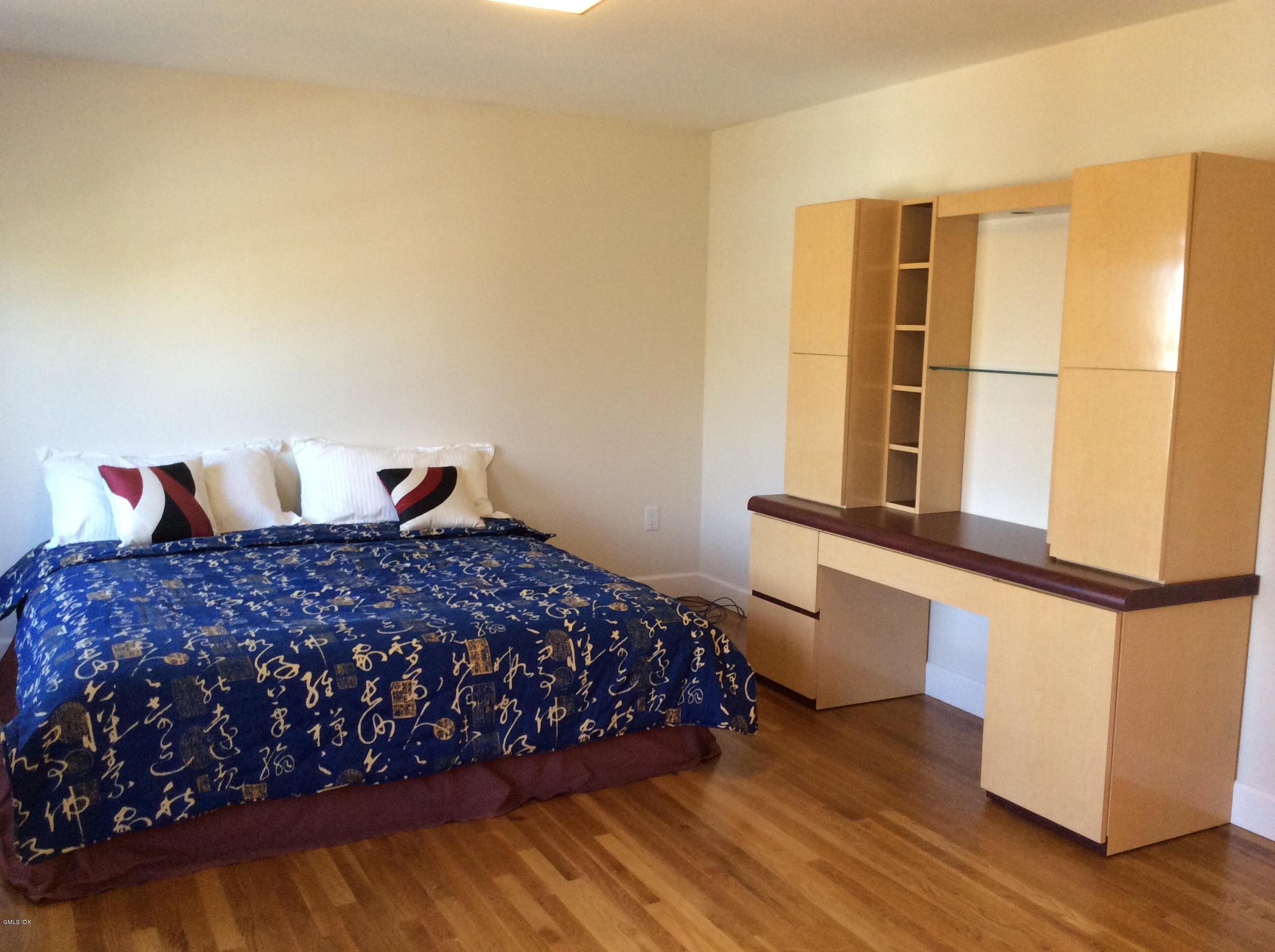 3 Stanwich Road Greenwich, CT 06830 - Photo 8 of 17 a bedroom with a bed and wooden floor