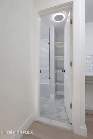 an empty room with a window and a ceiling fan