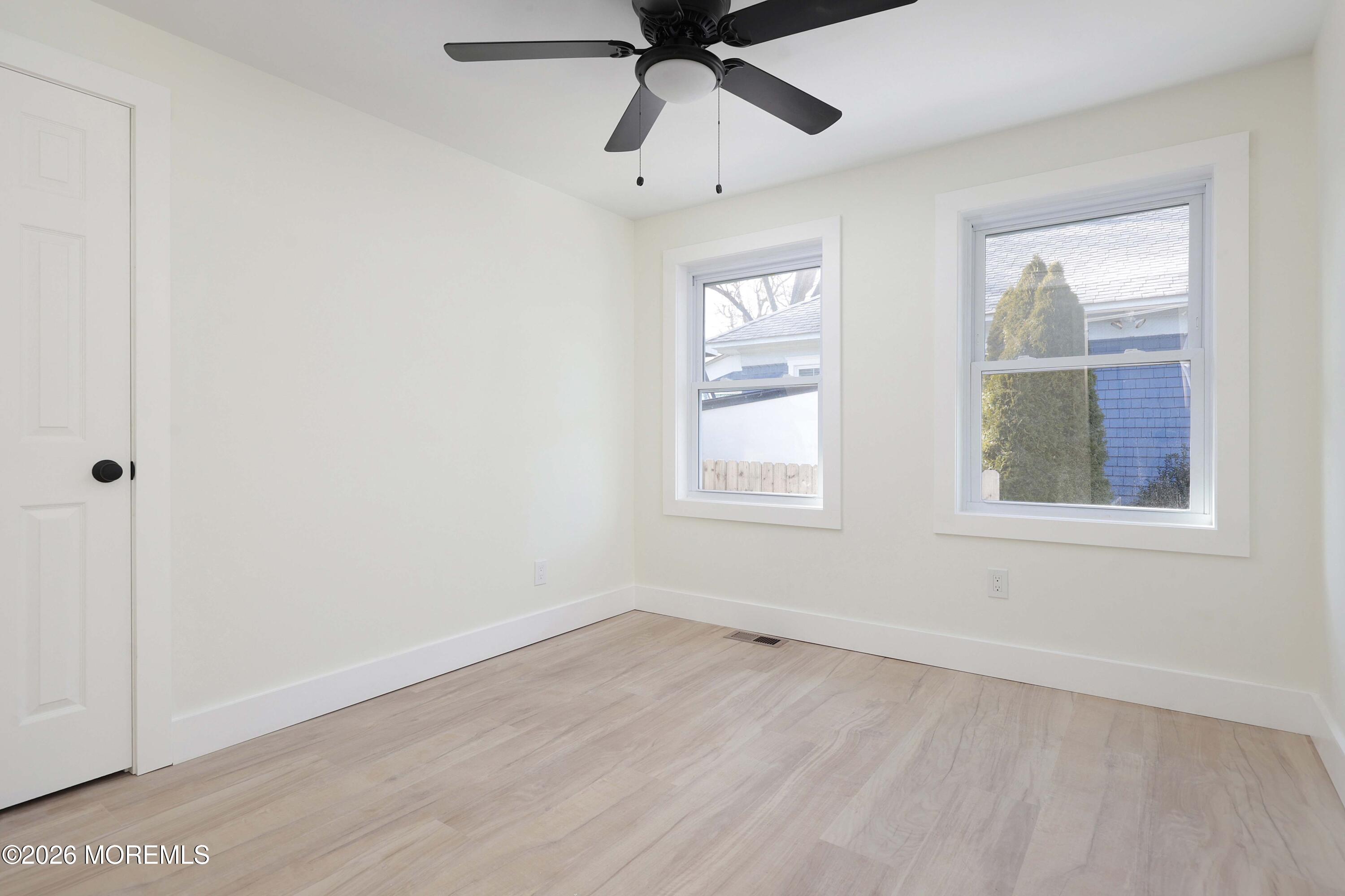 1216 8th Avenue Neptune, NJ 07753 - Photo 22 of 29 an empty room with a window and a ceiling fan