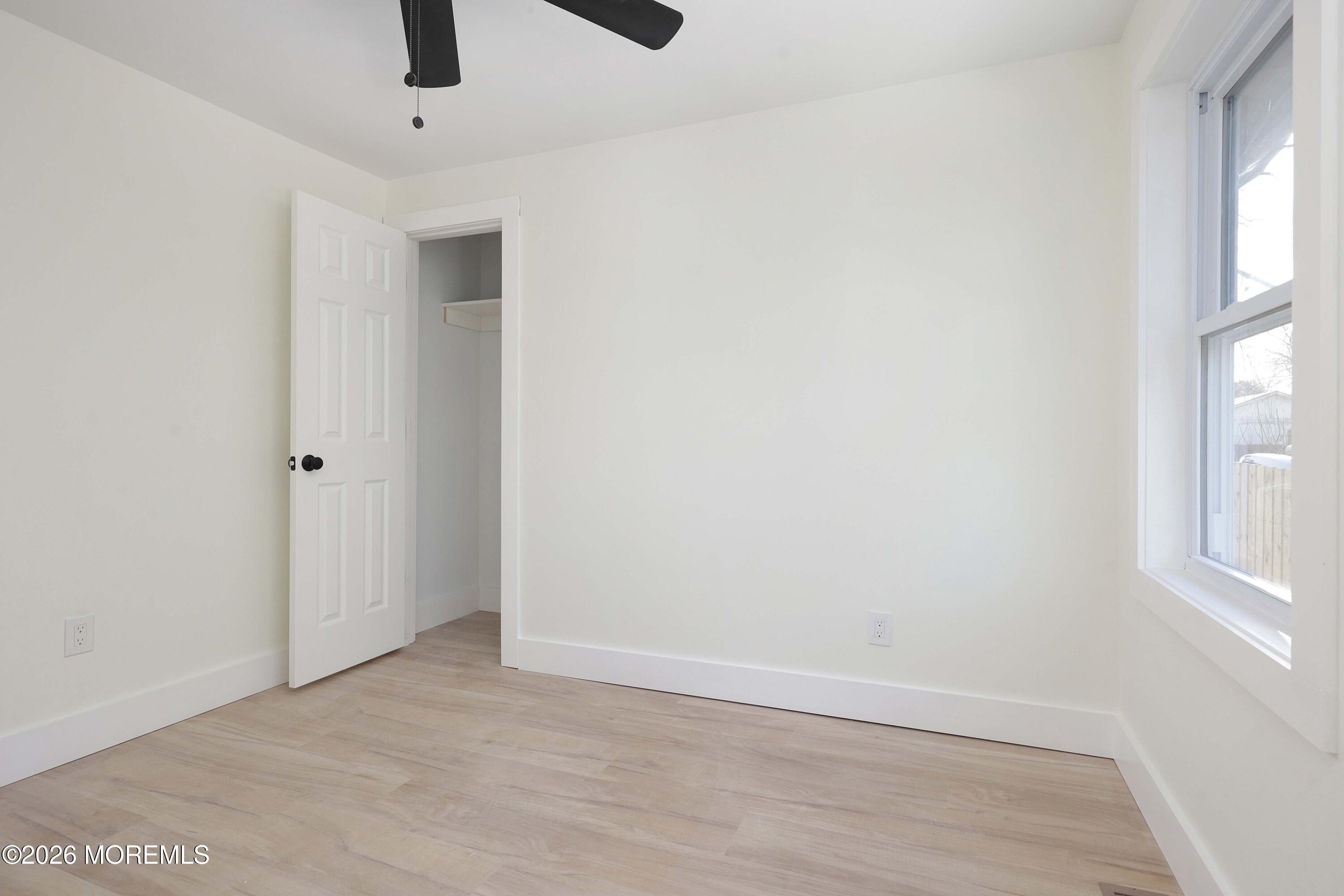 1216 8th Avenue Neptune, NJ 07753 - Photo 25 of 29 wooden floor in an empty room with a window