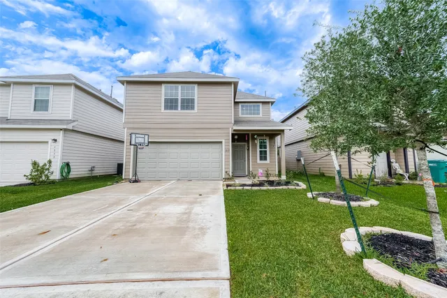 a front view of a house with a yard and garage
